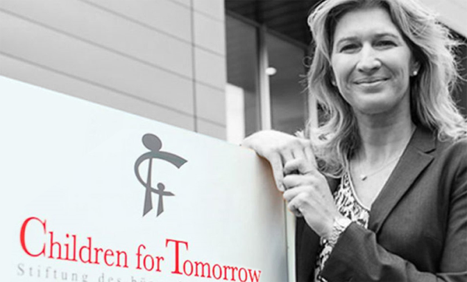 Stefani Graf posing with a Children for Tomorrow sign.